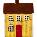 Maison avec bougie chauffe-plat jaune